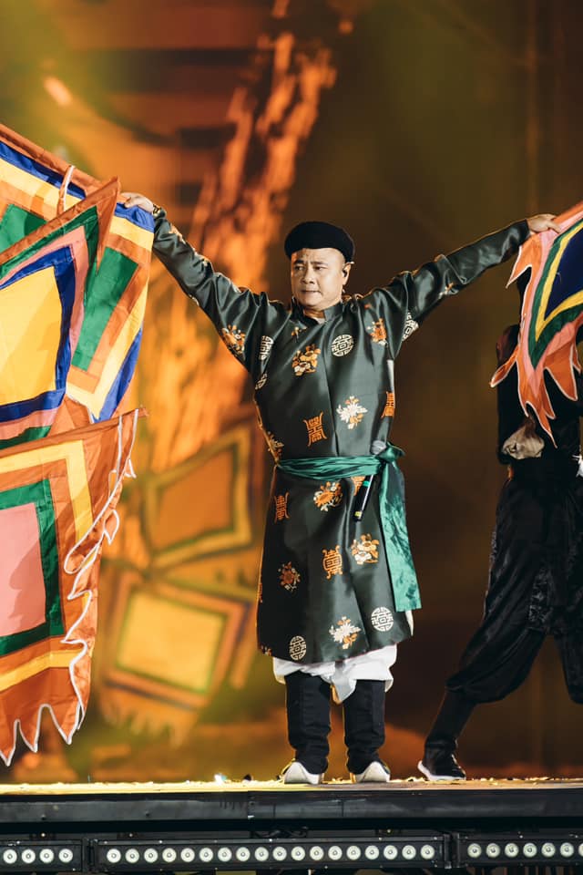 NSND Tự Long cúi đầu cảm ơn khán giả dưới mưa